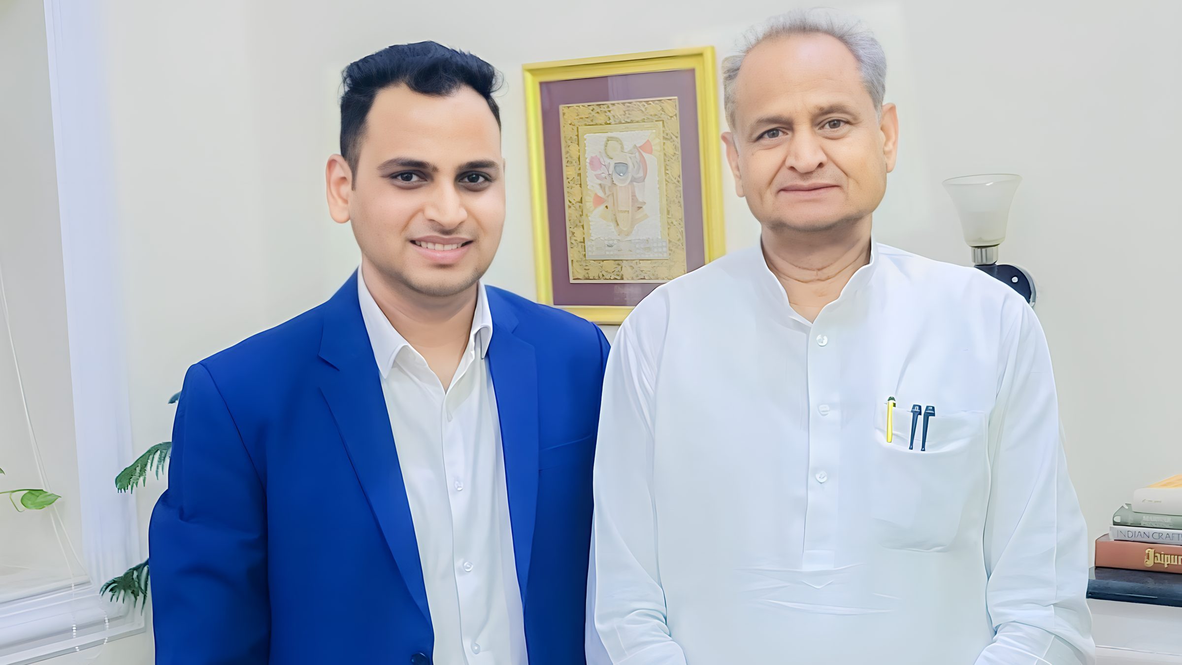 Lithvik Mukesh Sharma is photographed with Ashok Gehlot at a business meeting.
