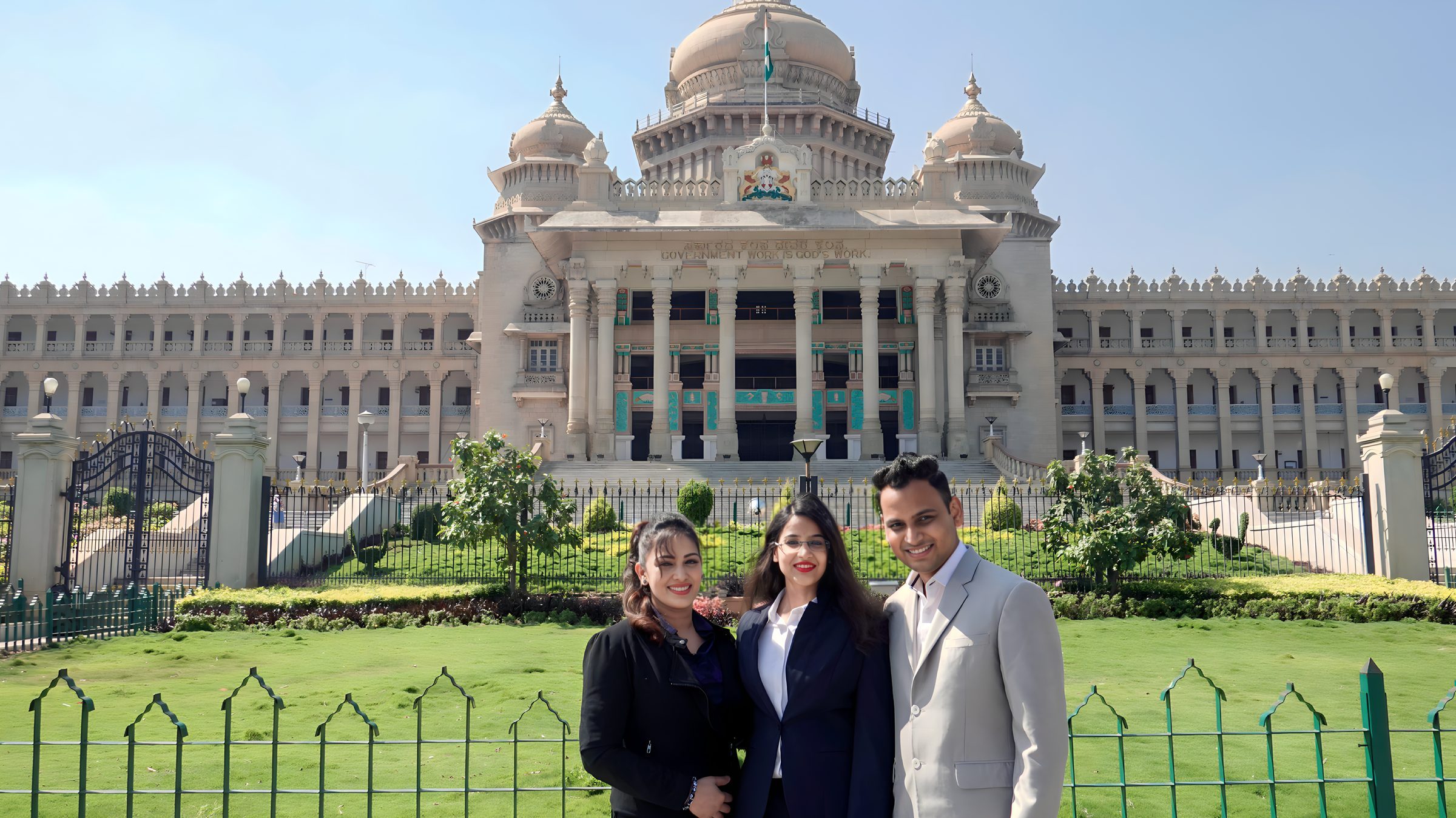 Lithvik Mukesh Sharma is photographed with Dr. Jyoti Kush and Ruksha at the Karnataka Vidhan Sabha building.